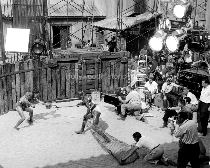 Spartacus 1960 Kirk Douglas and Woody Strode in fight scene director Stanley Kubrick seated on right WM.jpg